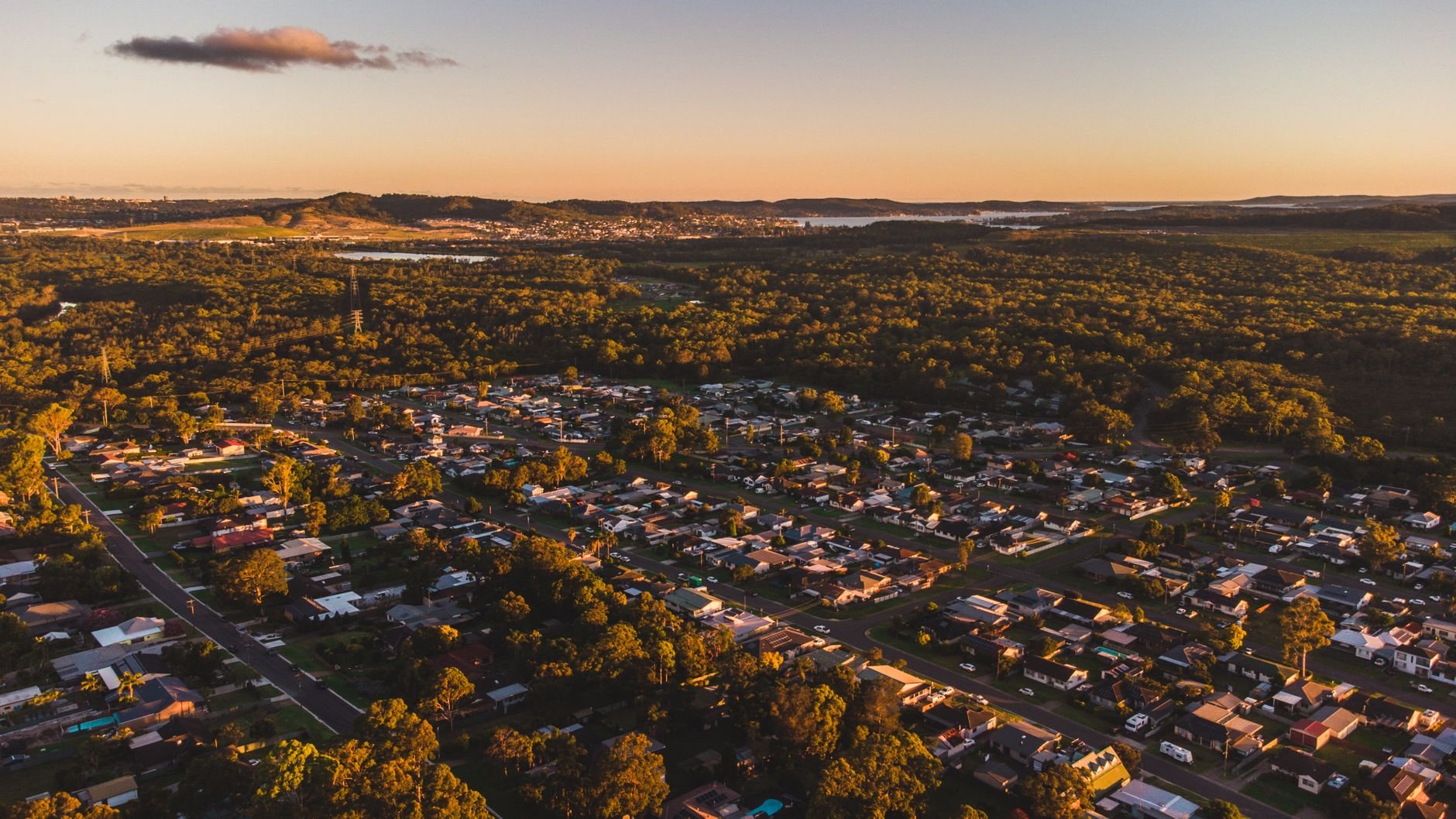 Aerial view of a residential neighborhood at warm sunset.
